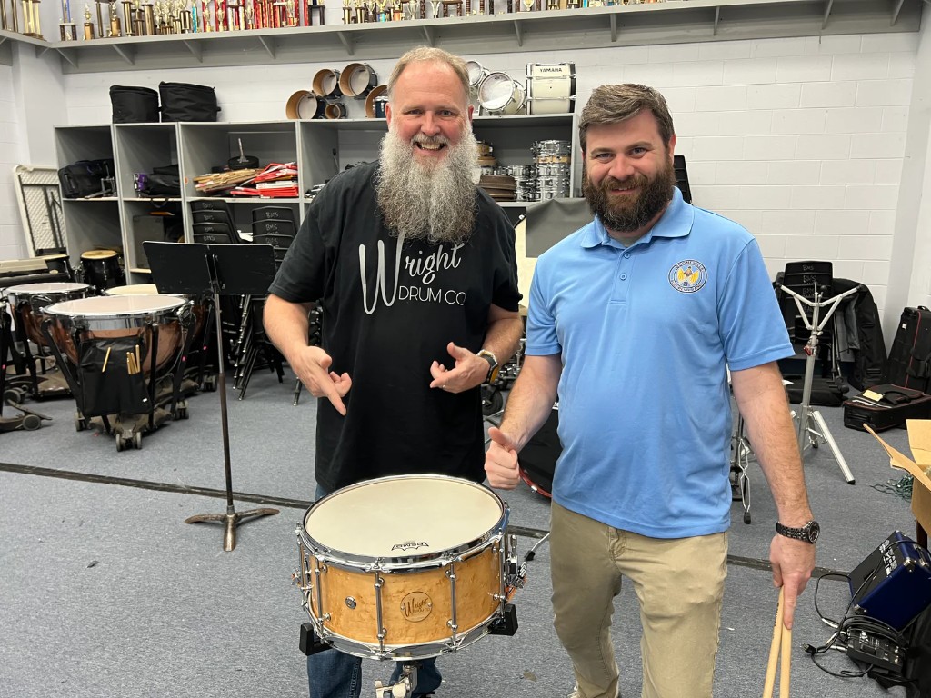 Wright Drum Co. builder and Booneville Blue Devil Band representative with the donated Birdseye Maple Philharmonic snare drum in the band room.